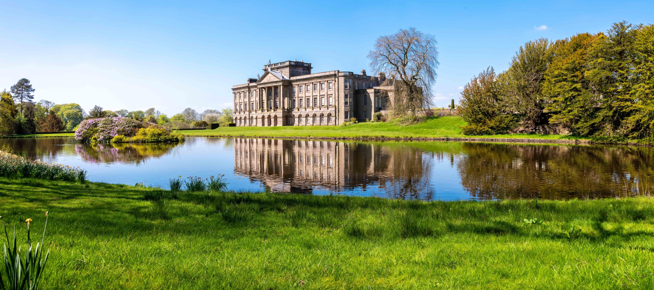 Lyme Park - showing a stately home and lake